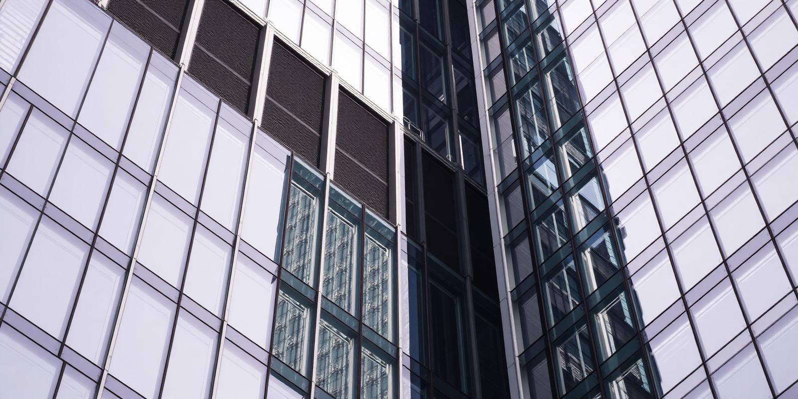 Glass and steel facade of a modern commercial building, representing institutional private credit.